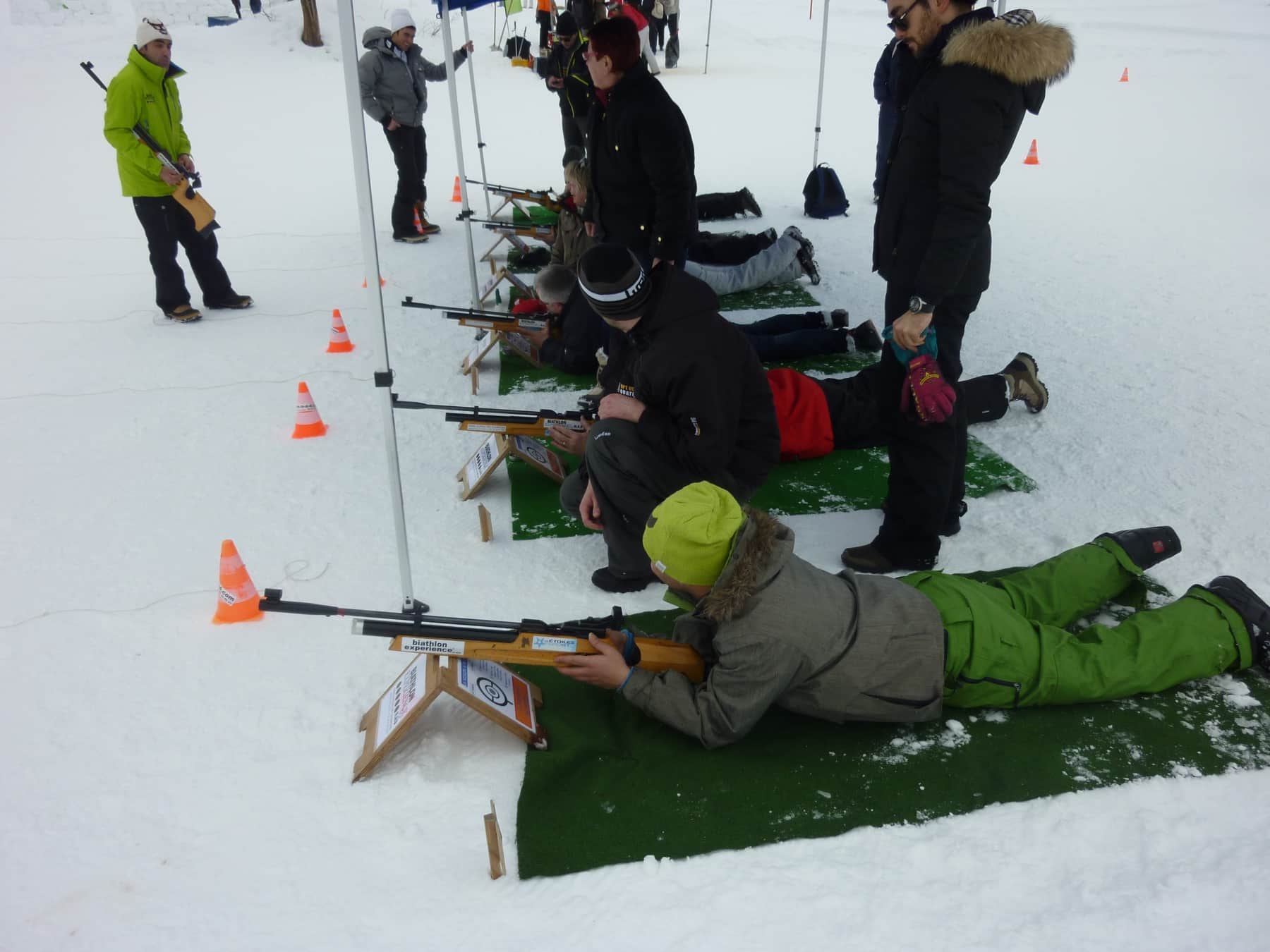 Corporate participants on the shooting range of a laser biathlon workshop on snow