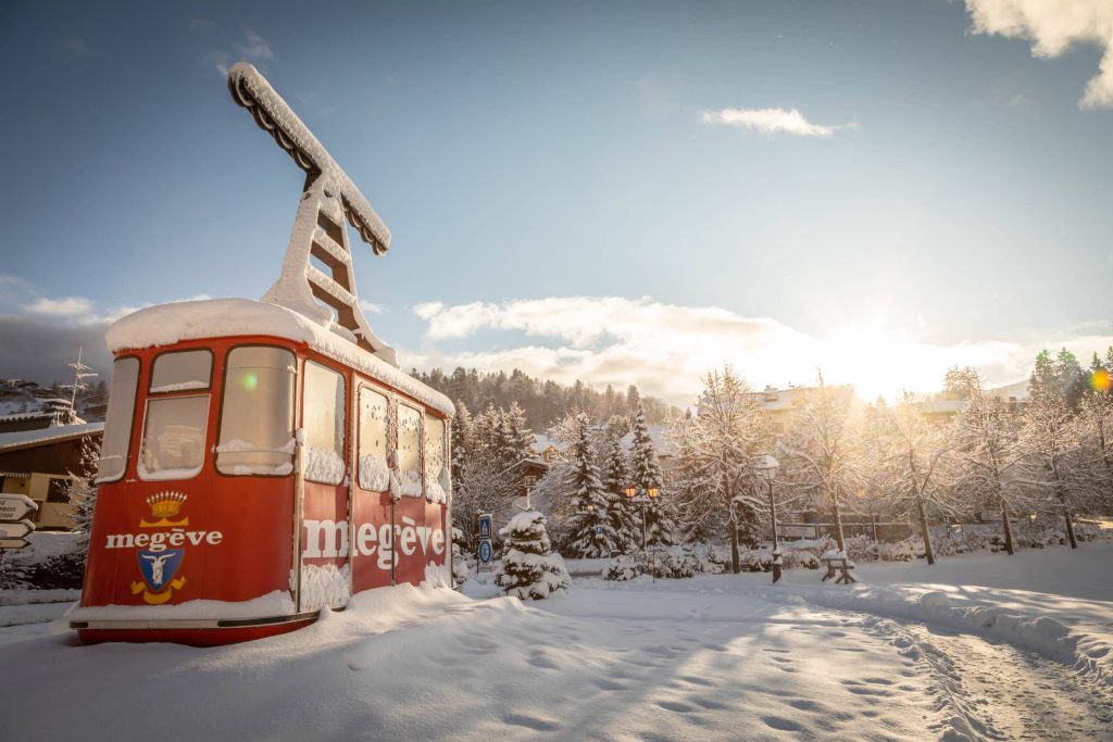 Megeve in winter, the old red cable car under snow