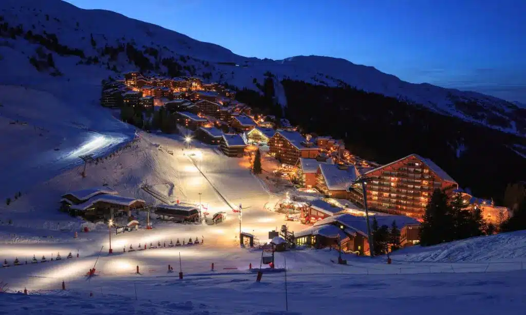 Meribel at night, chalets and floodlit slopes