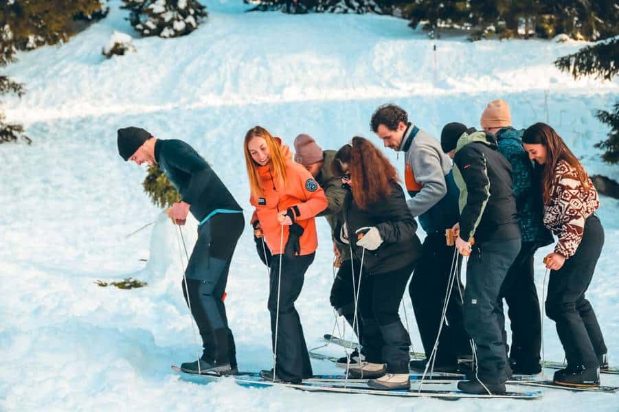 Corporate team on giant skis during snow olympics